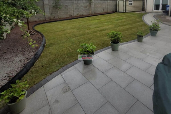Granite Slabbed Patio with Charcoal Kerbing and Turf Lawn in Douglas, Cork