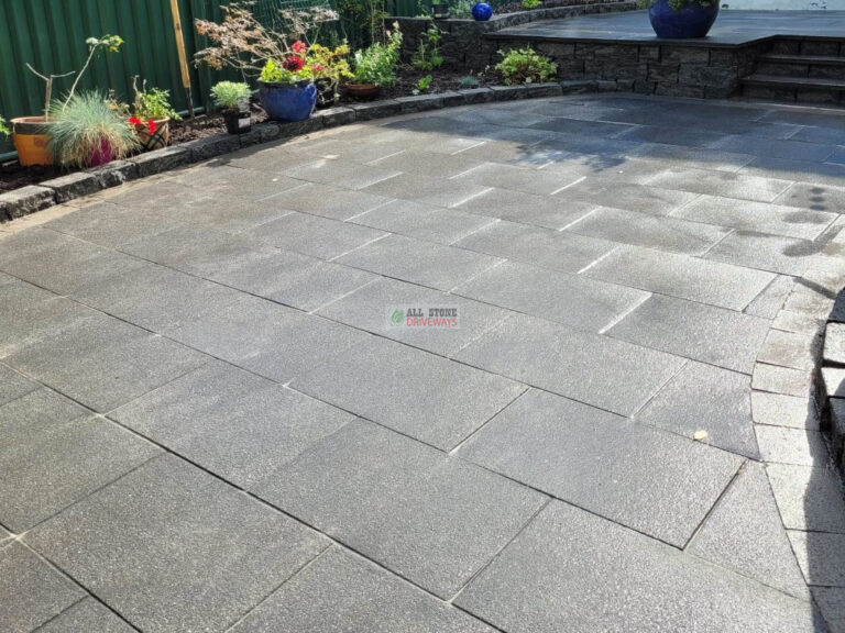 Patio with Black Granite Slabs and Natural Brick Border in Cork