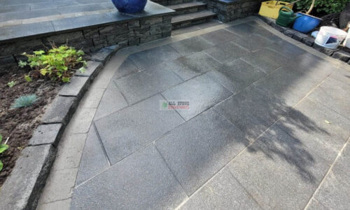 Patio with Black Granite Slabs and Natural Brick Border in Cork
