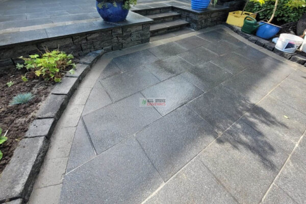 Patio with Black Granite Slabs and Natural Brick Border in Cork