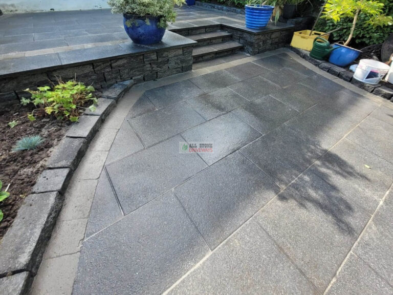 Patio with Black Granite Slabs and Natural Brick Border in Cork